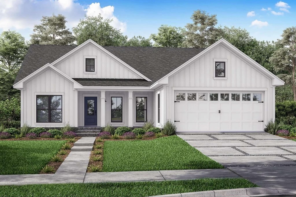 modern inspired farmhouse with a front lawn and a garage