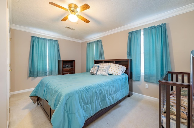 carpeted bedroom featuring a textured ceiling, ceiling fan, and ornamental molding