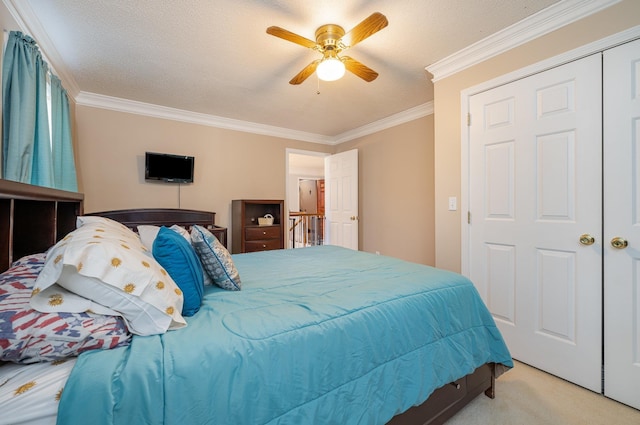 bedroom with a textured ceiling, ceiling fan, crown molding, and light colored carpet