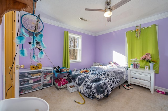 carpeted bedroom featuring ceiling fan, crown molding, and a textured ceiling