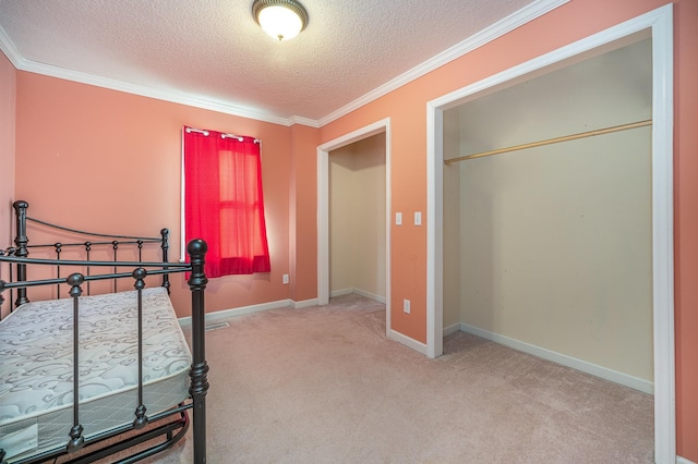 bedroom with a textured ceiling, light colored carpet, and ornamental molding