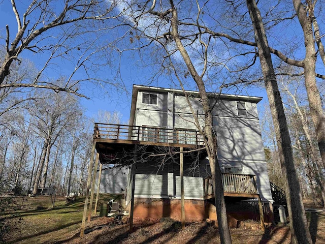 rear view of house featuring a wooden deck