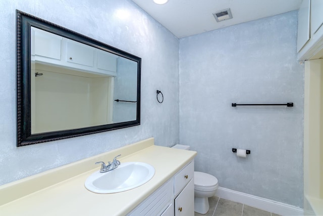 bathroom with tile patterned flooring, vanity, and toilet