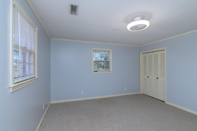 carpeted spare room with crown molding