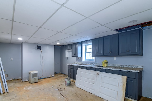 kitchen with blue cabinets and a drop ceiling