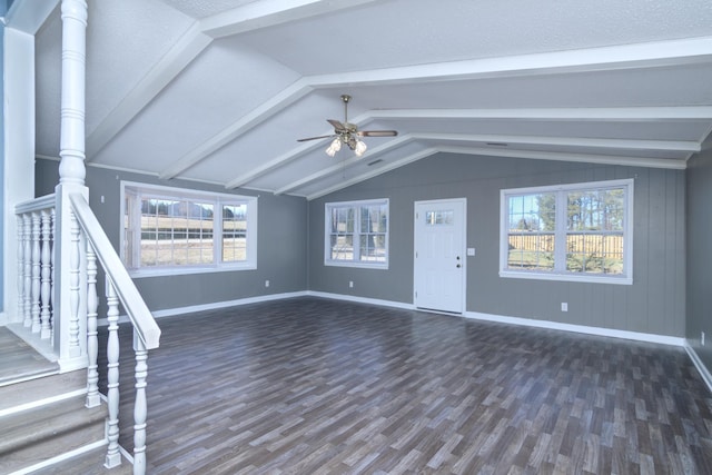 unfurnished living room with ceiling fan, lofted ceiling with beams, and dark hardwood / wood-style floors