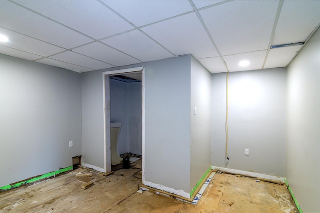 basement with a paneled ceiling