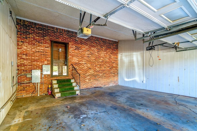 garage with a garage door opener and wood walls