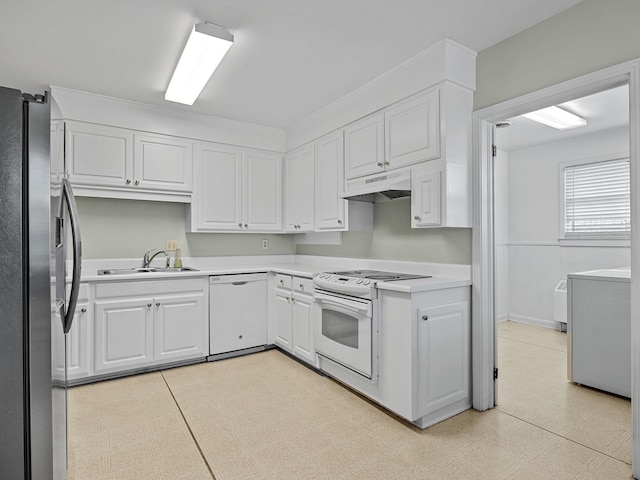 kitchen with sink, washer / clothes dryer, white appliances, and white cabinets