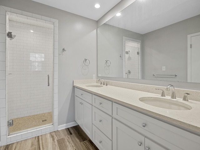 bathroom with a shower with door and vanity