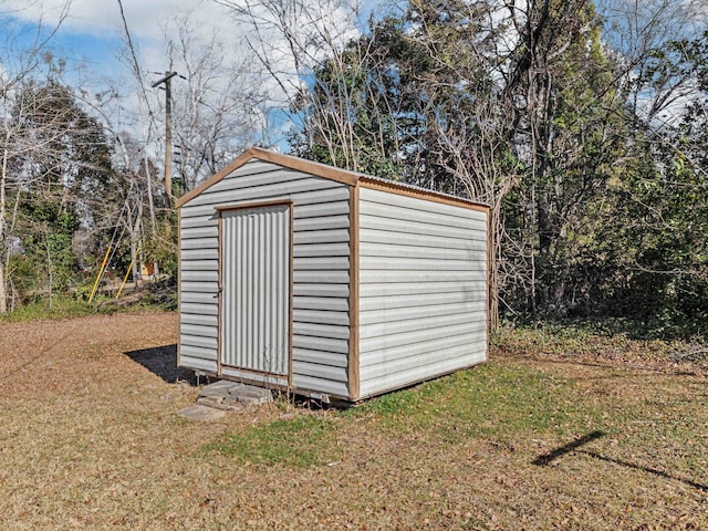 view of outbuilding with a yard