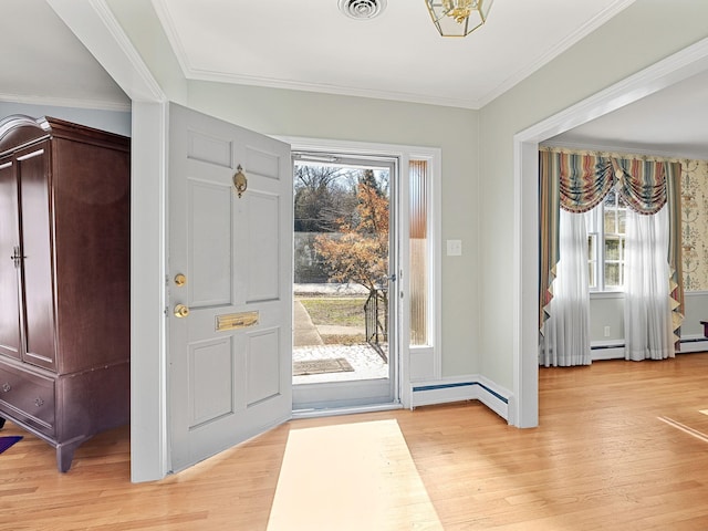 entryway featuring light wood-type flooring, a wealth of natural light, and crown molding