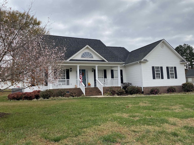 view of front of house with a front yard and covered porch