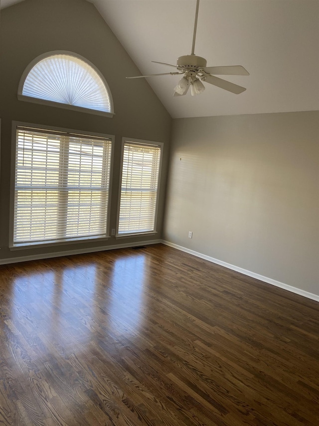 unfurnished room featuring ceiling fan, dark hardwood / wood-style flooring, and a wealth of natural light