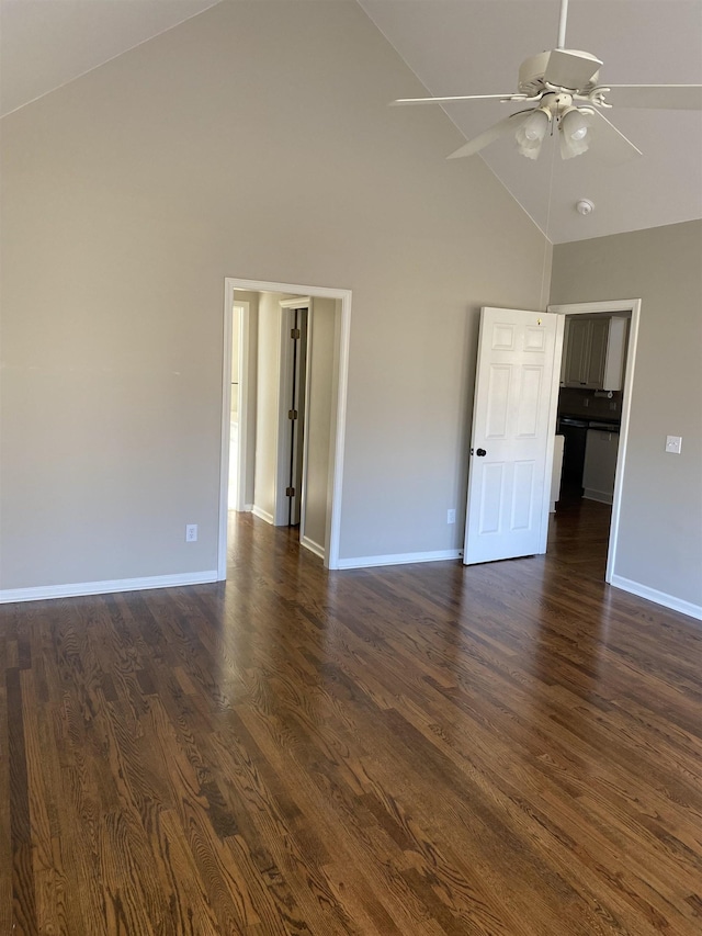 spare room with dark wood-type flooring, high vaulted ceiling, and ceiling fan