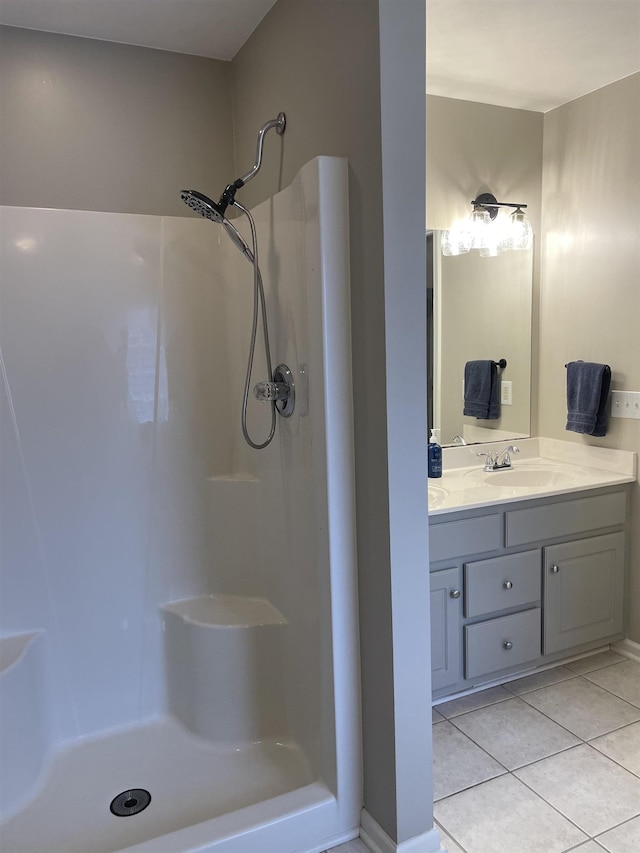 bathroom featuring a shower, tile patterned floors, and vanity