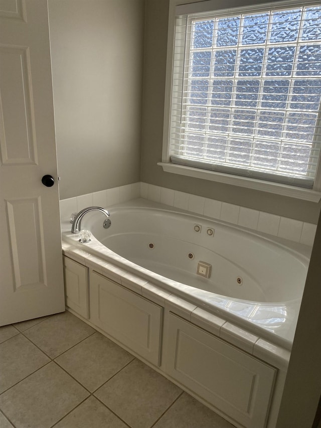 bathroom with a wealth of natural light, tile patterned floors, and a bathing tub