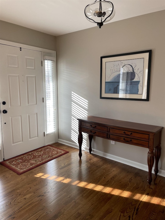 entrance foyer featuring a notable chandelier and dark hardwood / wood-style flooring