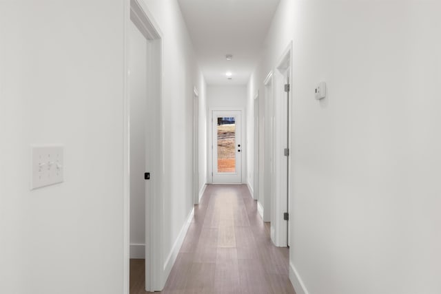 hall with light hardwood / wood-style floors