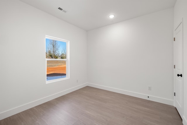 empty room with light hardwood / wood-style flooring