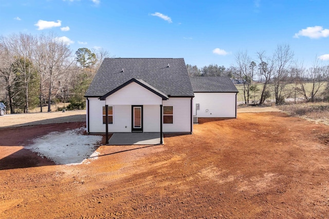 back of property with central air condition unit and a patio area