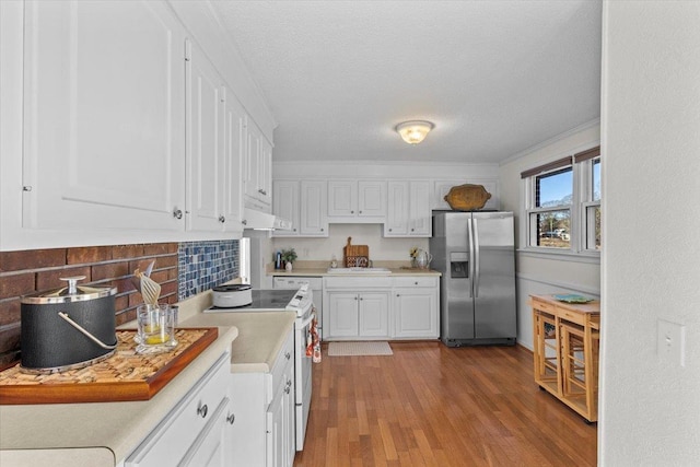 kitchen featuring a textured ceiling, light hardwood / wood-style flooring, stainless steel refrigerator with ice dispenser, white cabinetry, and sink