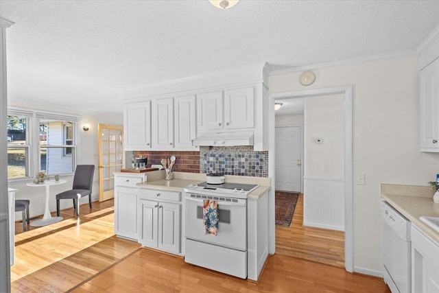 kitchen with white cabinetry, white appliances, light hardwood / wood-style flooring, decorative backsplash, and crown molding