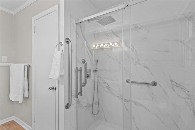 bathroom with ornamental molding and walk in shower