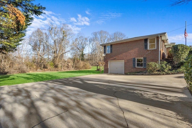 view of side of property featuring a yard and a garage