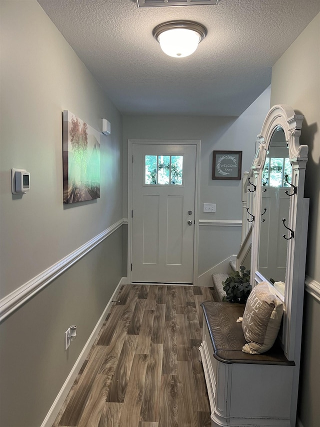 entryway featuring a textured ceiling and dark hardwood / wood-style flooring