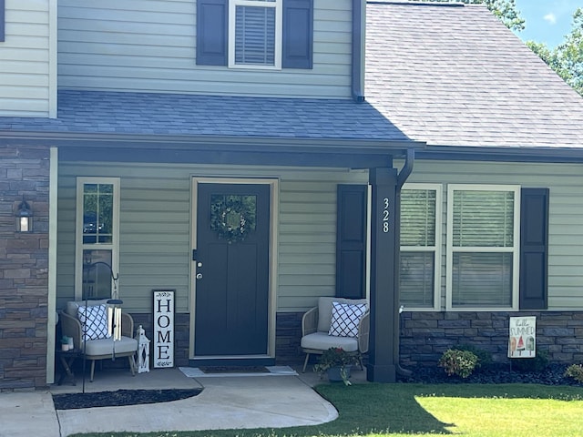 doorway to property featuring covered porch