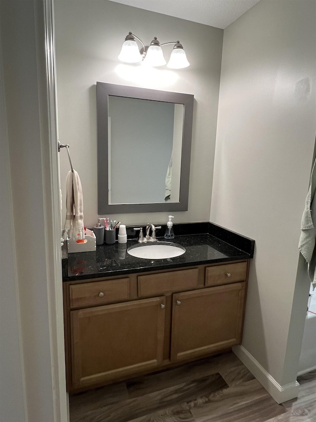 bathroom featuring hardwood / wood-style floors and vanity