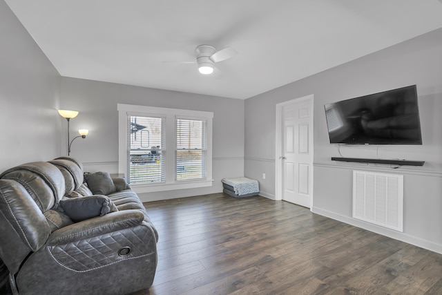 living room featuring dark hardwood / wood-style flooring and ceiling fan