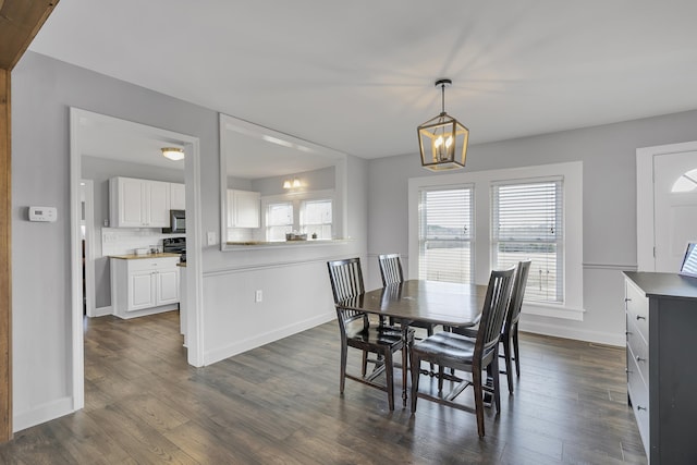 dining area featuring a chandelier and dark wood-type flooring