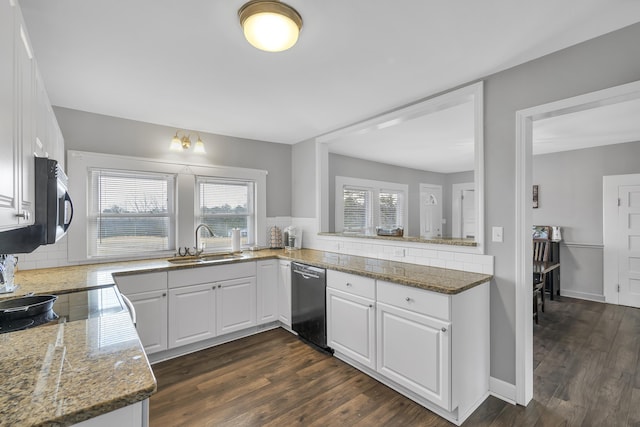 kitchen with sink, white cabinetry, dishwashing machine, and stone counters