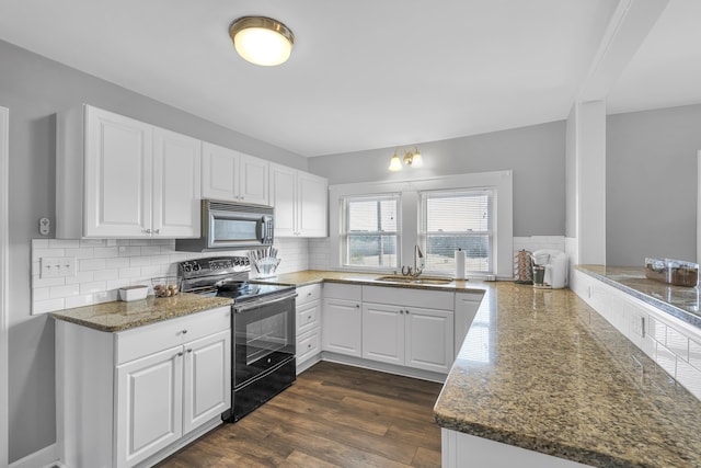 kitchen featuring sink, white cabinetry, black electric range oven, tasteful backsplash, and kitchen peninsula