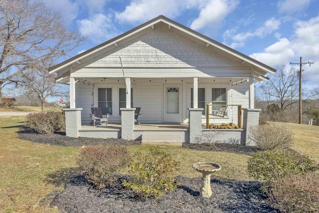 bungalow-style home with a porch and a front yard