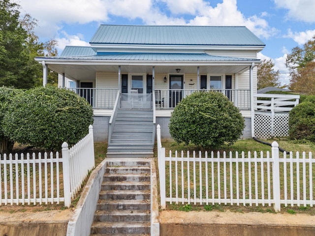 view of front of home with a front yard and covered porch