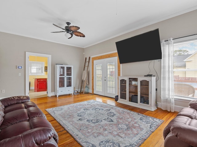 living room with ceiling fan, french doors, crown molding, and hardwood / wood-style floors