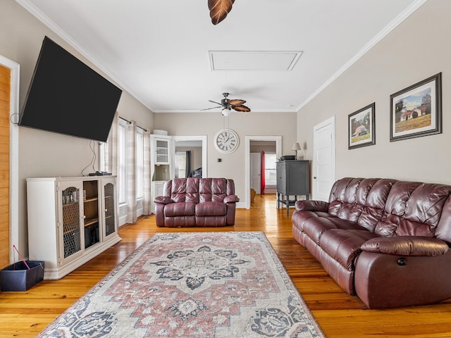 living room featuring ornamental molding and wood-type flooring