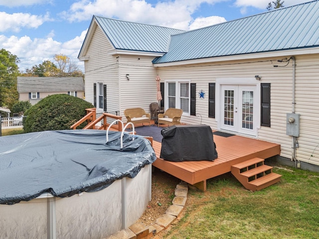 exterior space with outdoor lounge area, french doors, a lawn, and a wooden deck