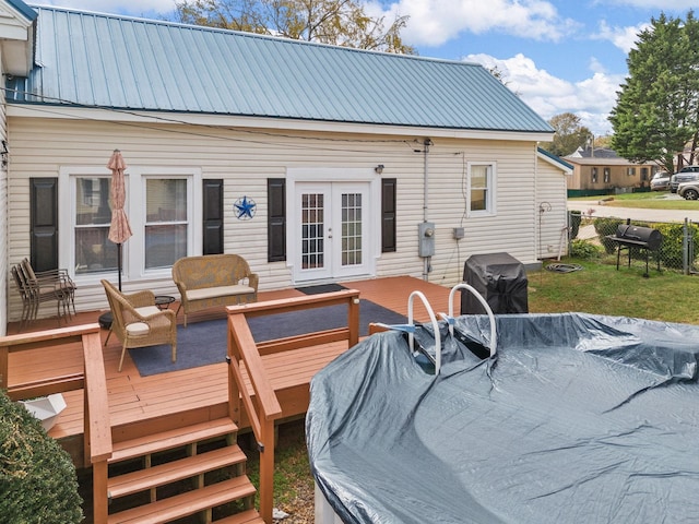 rear view of house with french doors and a deck