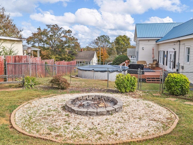 view of yard featuring an outdoor fire pit and a swimming pool side deck