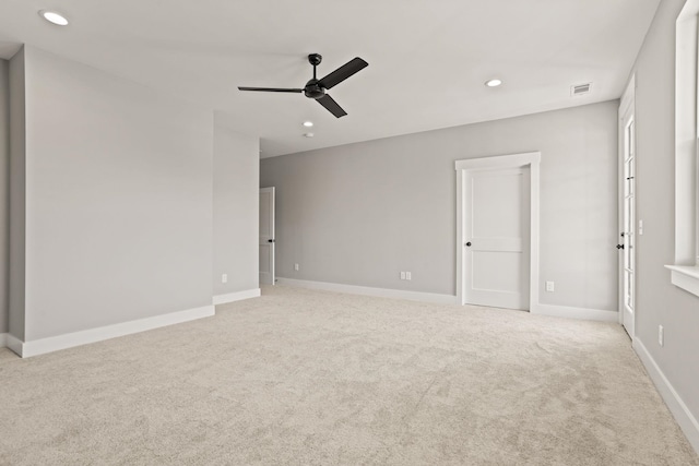 unfurnished room featuring light colored carpet and ceiling fan