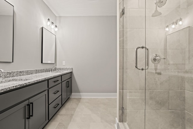 bathroom featuring a shower with shower door and vanity