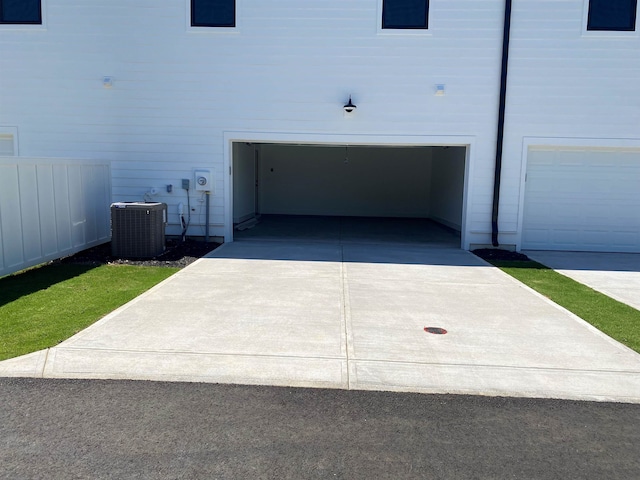 view of side of property with cooling unit and a garage