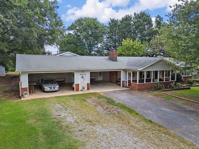 ranch-style home featuring a carport, a porch, a garage, and a front yard