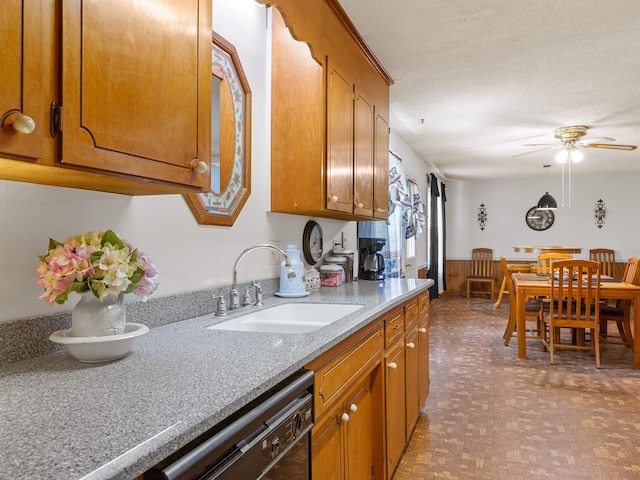 kitchen with sink, a textured ceiling, ceiling fan, and black dishwasher