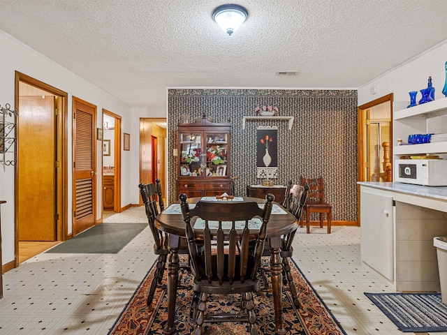 dining area featuring a textured ceiling