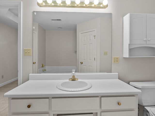 bathroom with toilet and vanity